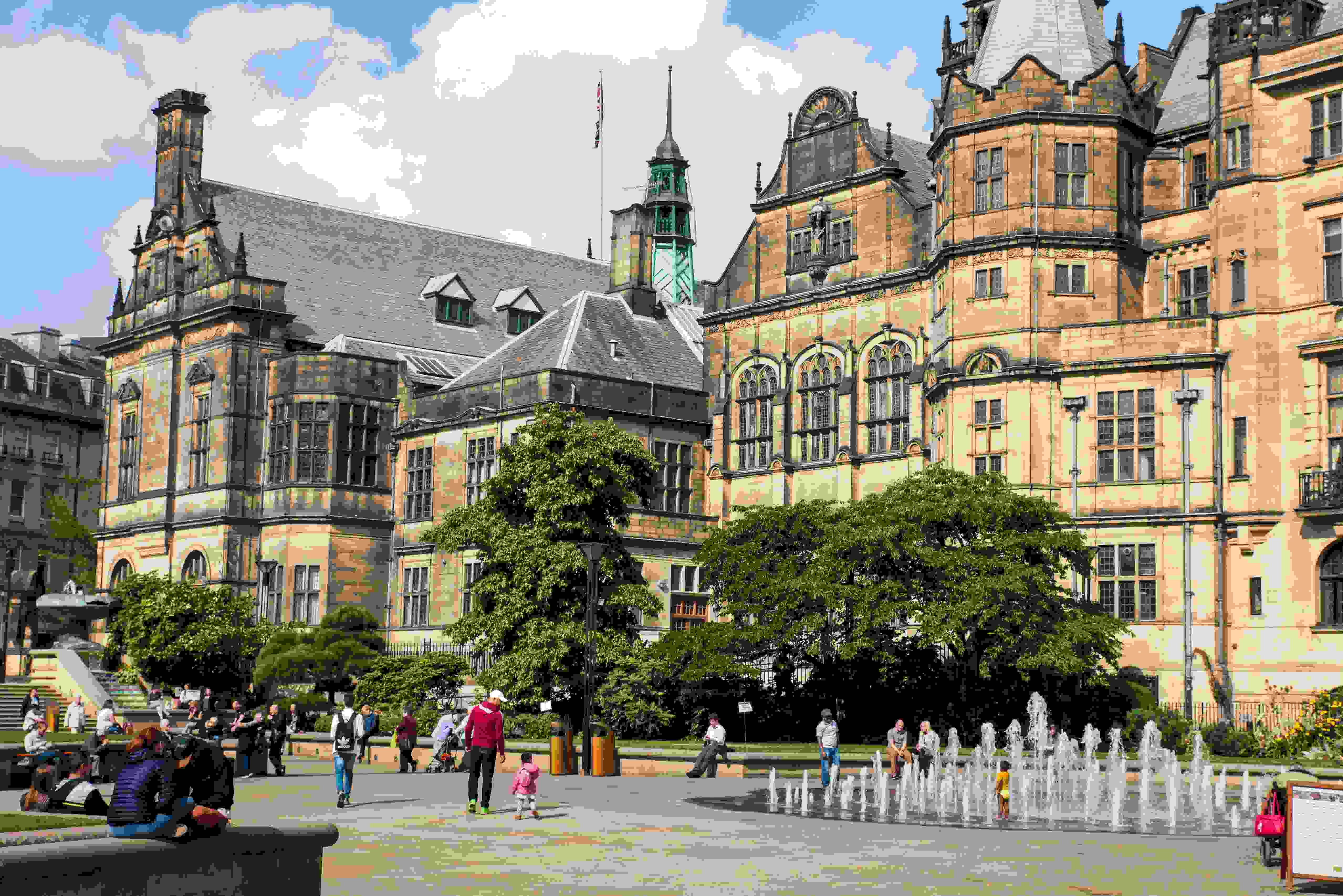 Town Hall and Peace Gardens, fountain on, people walking through the gardens