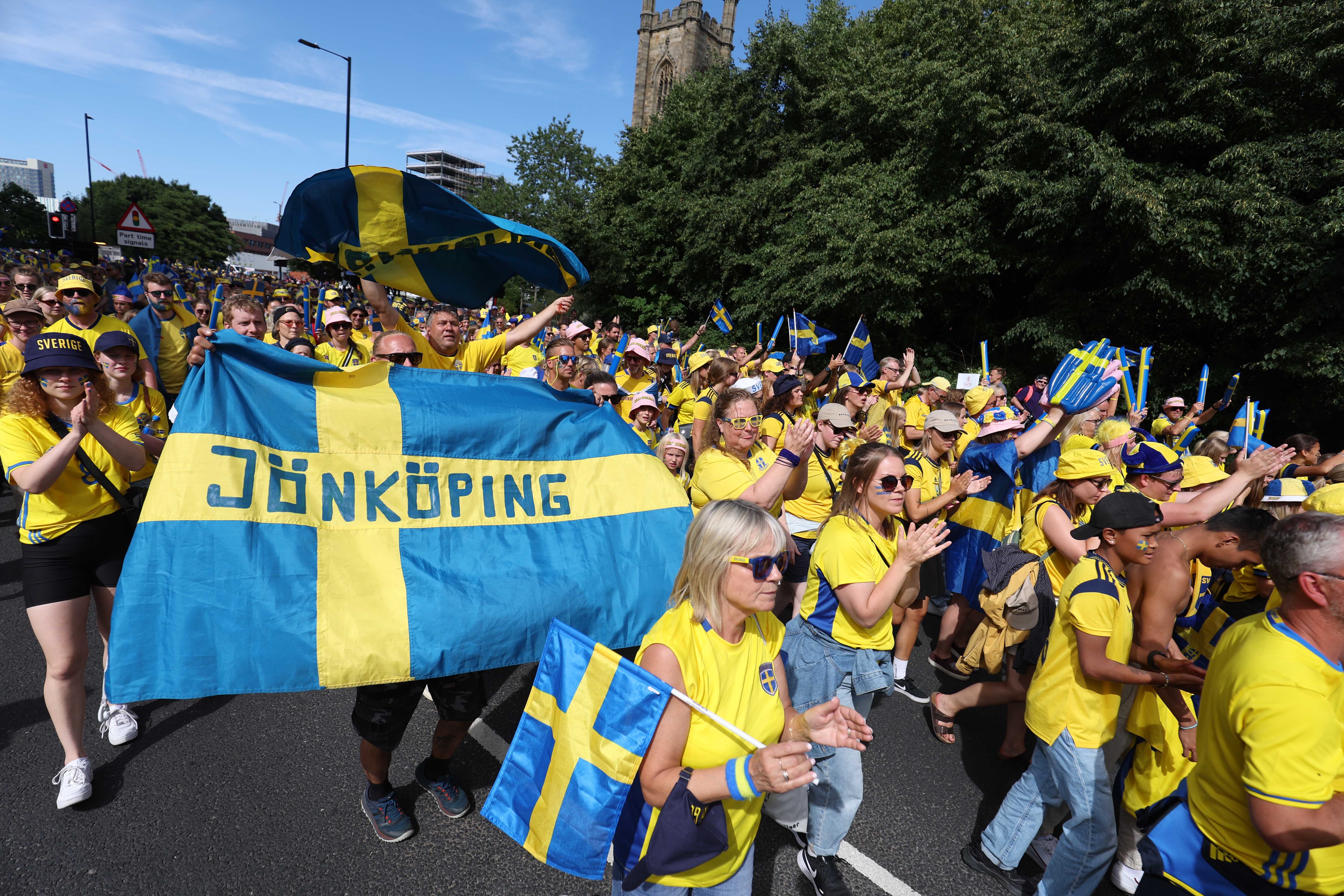 Thousands of fans from Sweden walk through Sheffield with flags and banners dressed in blue and yellow