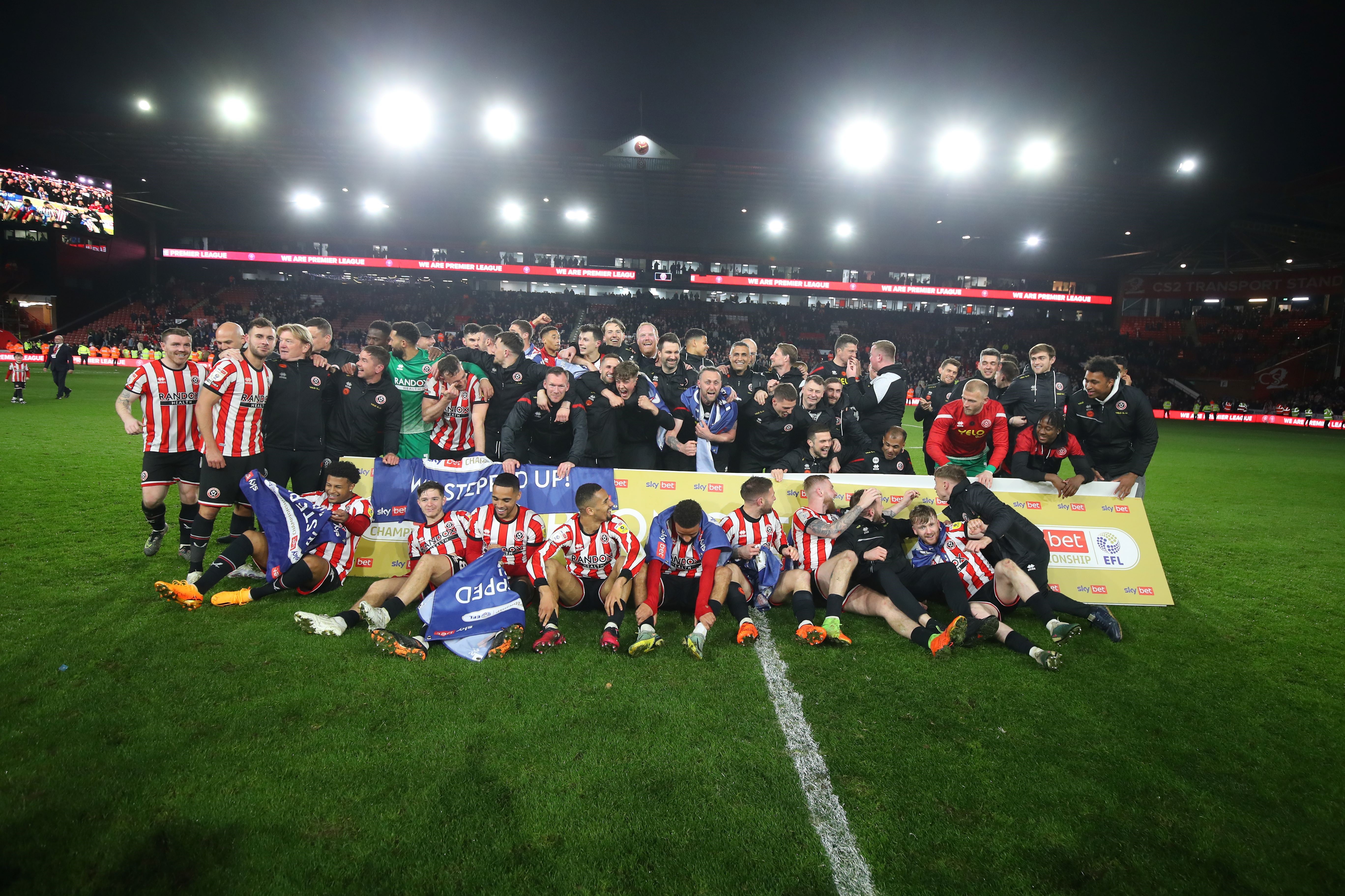 Sheffield United football players, huddled together for a picture on the pitch inside the stadium
