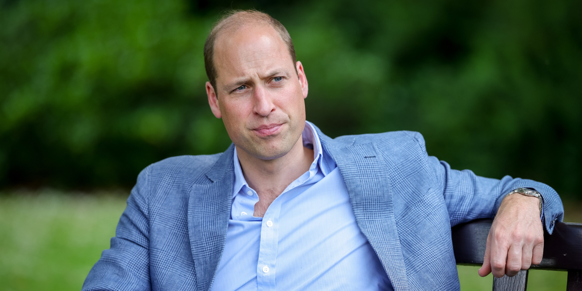 Prince William sat down on a bench wearing a blue shirt and darker blue blazer
