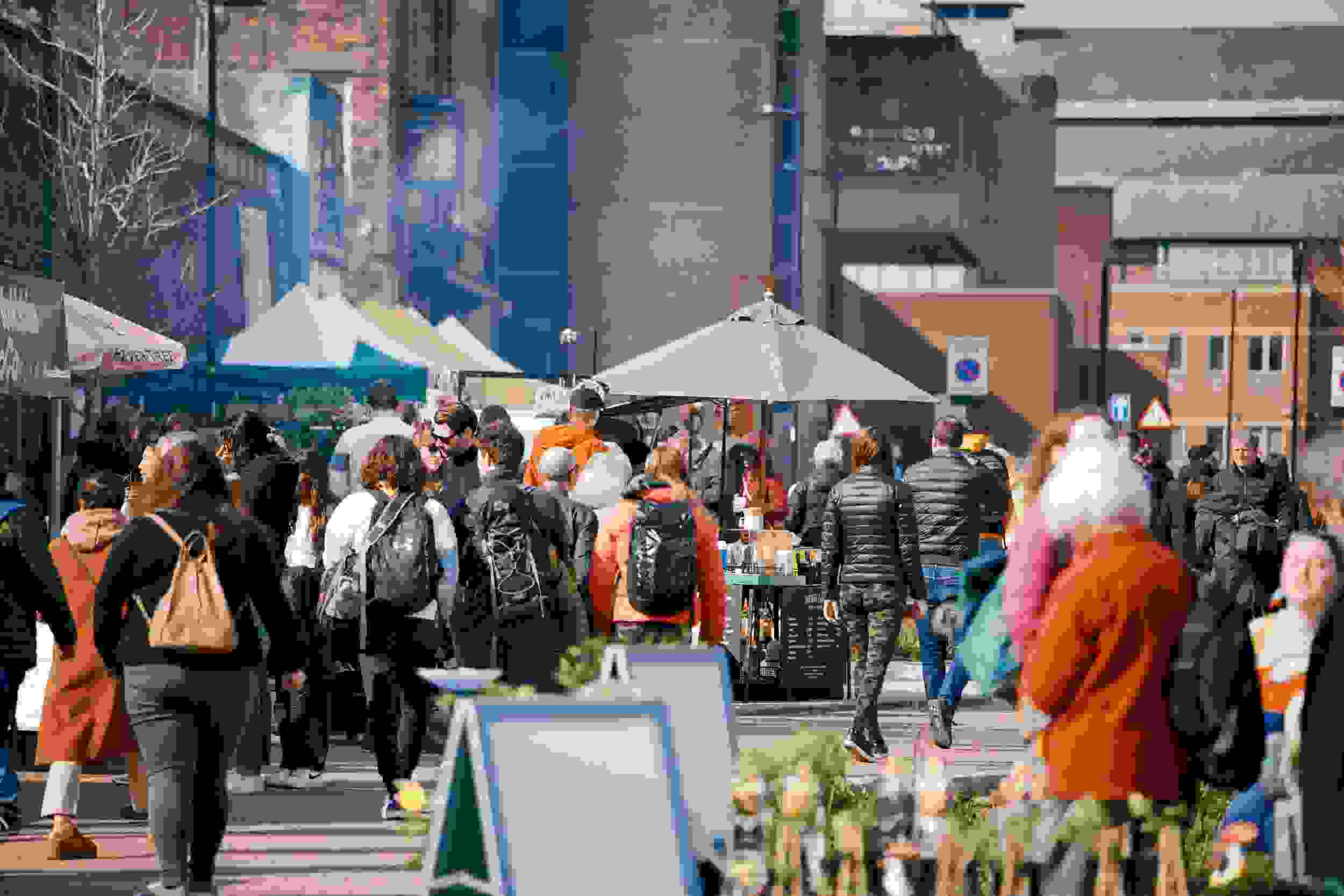 People walking through a city centre market