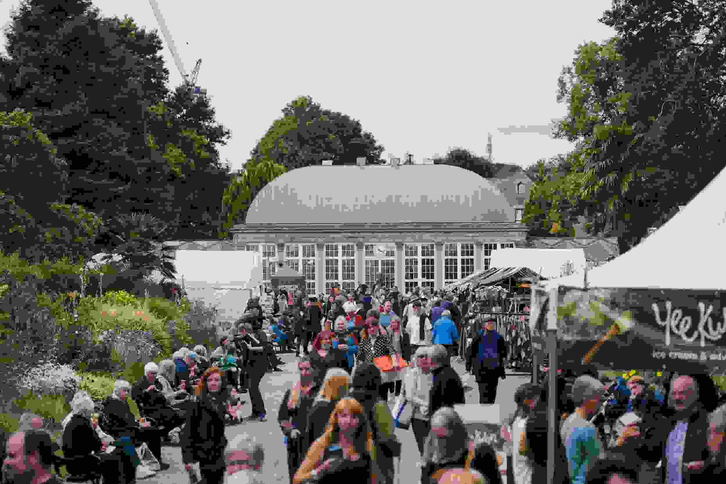 A shot of Sheffield's Botanical Gardens greenhouse, with lots of people walking on the path in front