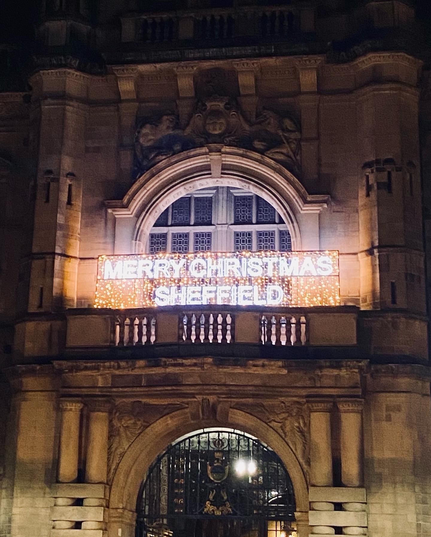 "Merry Christmas Sheffield" written in lights across the front of the Town Hall