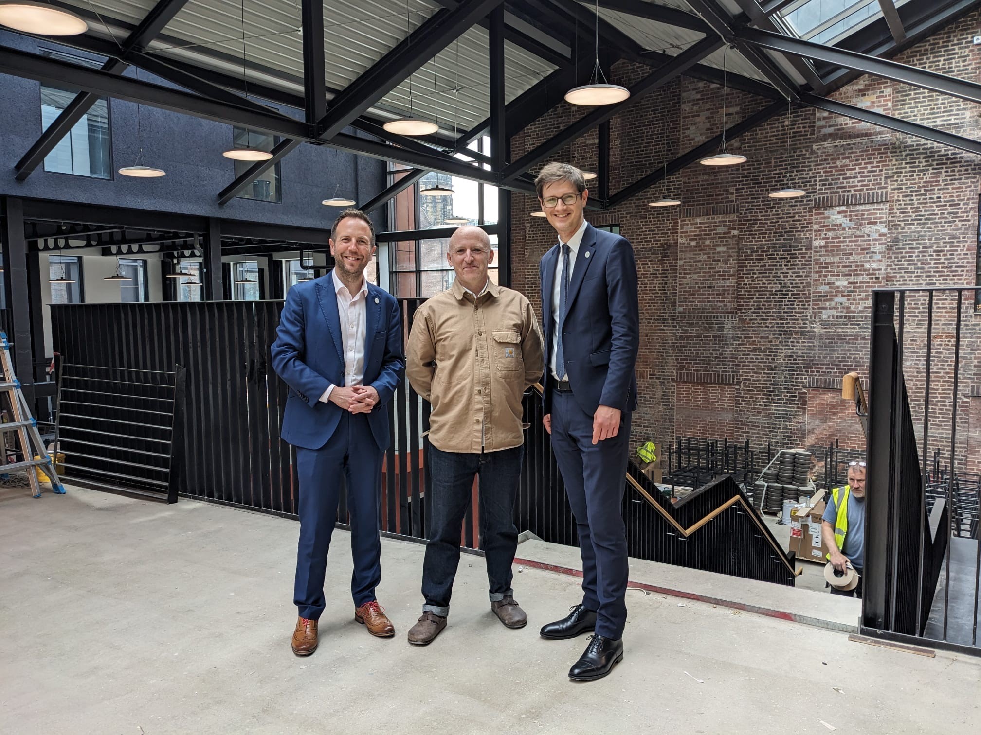 Cllr Ben Miskell, Matt Bigland and Cllr Tom Hunt stand on the first floor of Cambridge Street Collective food hall.