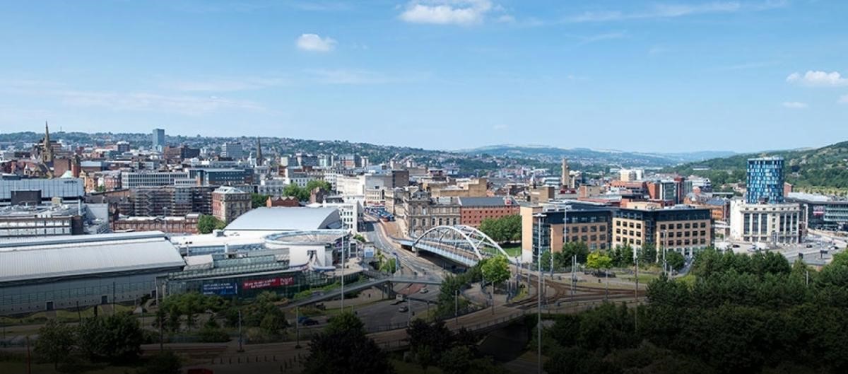 An image of Sheffield city centre showing park square roundabout with a road going off it and into the distance, the road is surrounded by Ponds Forge Leisure Centre and office blocks