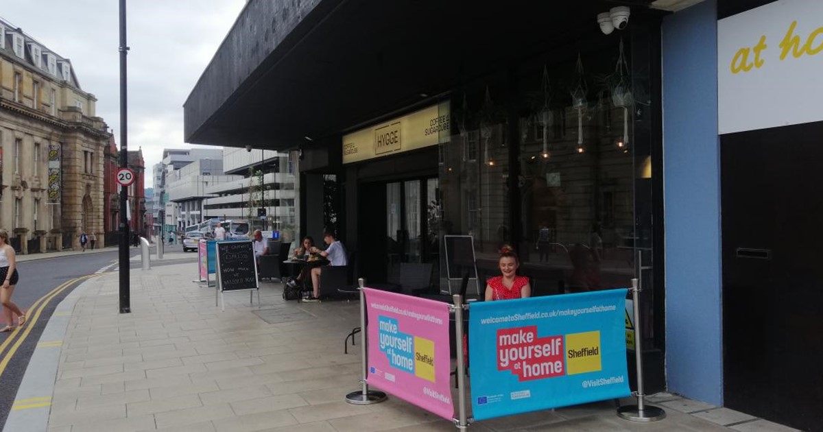 outdoor café seating with colourful barriers