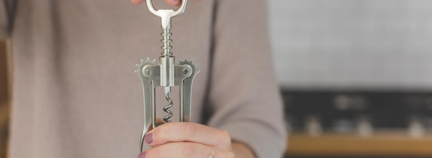 Adult holding corkscrew