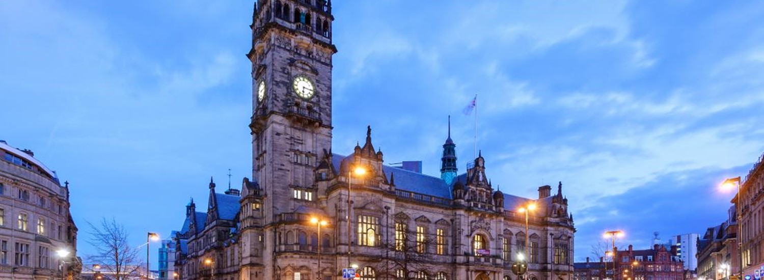 Sheffield Town Hall is lit up as the sun sets in the city