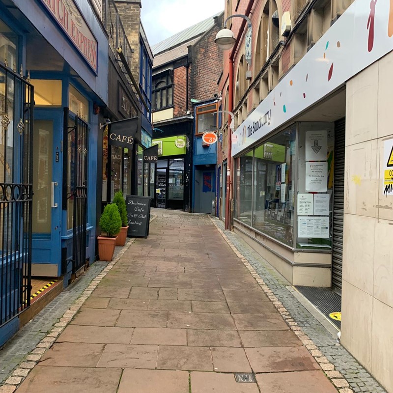 Empty side street with shops 