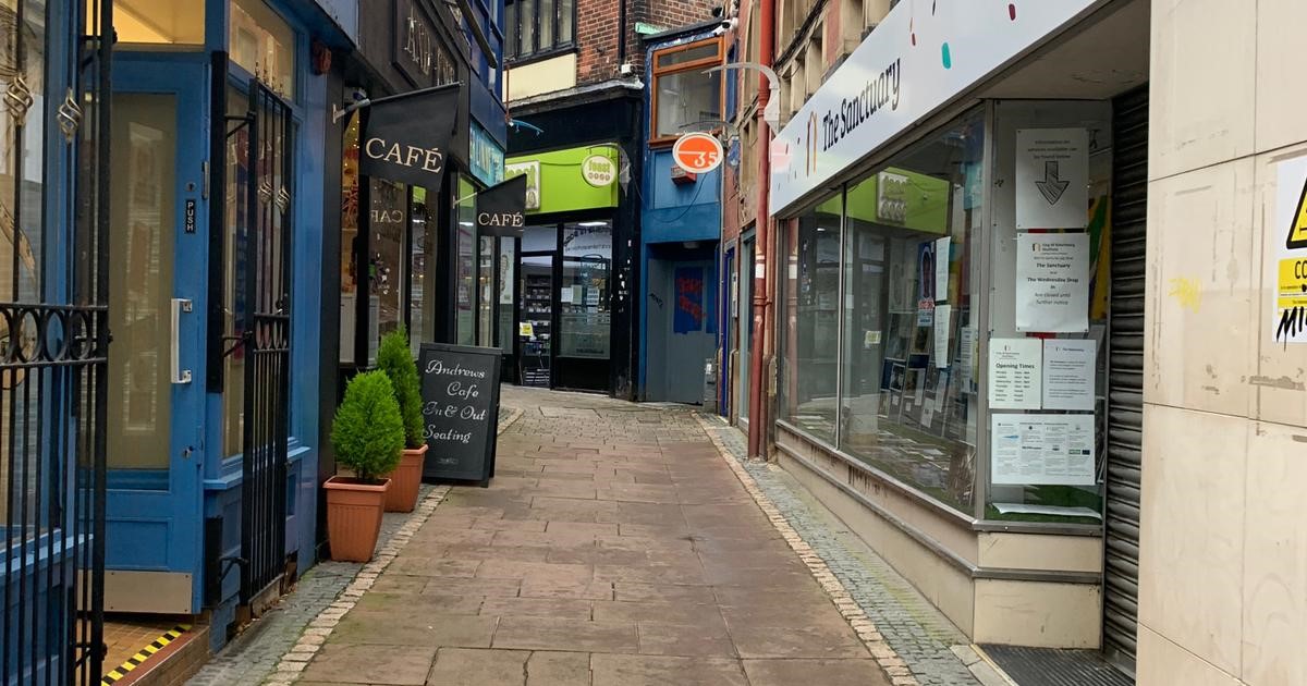 cafe with colourful barriers outside around outdoor seating