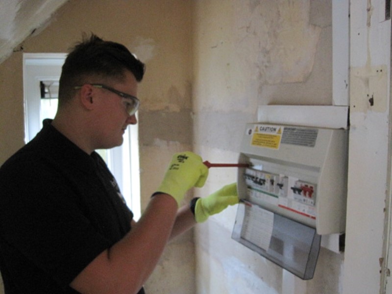 Jack Tyler at a fuse box with a screwdriver