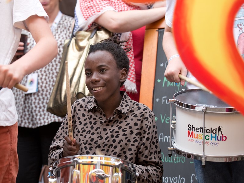 Young person playing drums