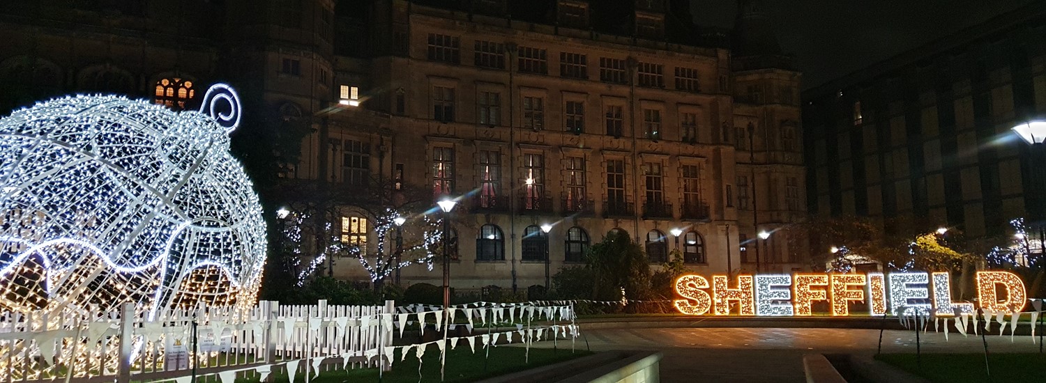 Large Christmas bauble lit up in Sheffield Peace Gardens