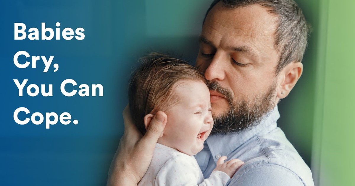 Man holding a crying baby