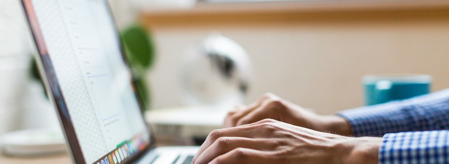 Close up of laptop with person typing