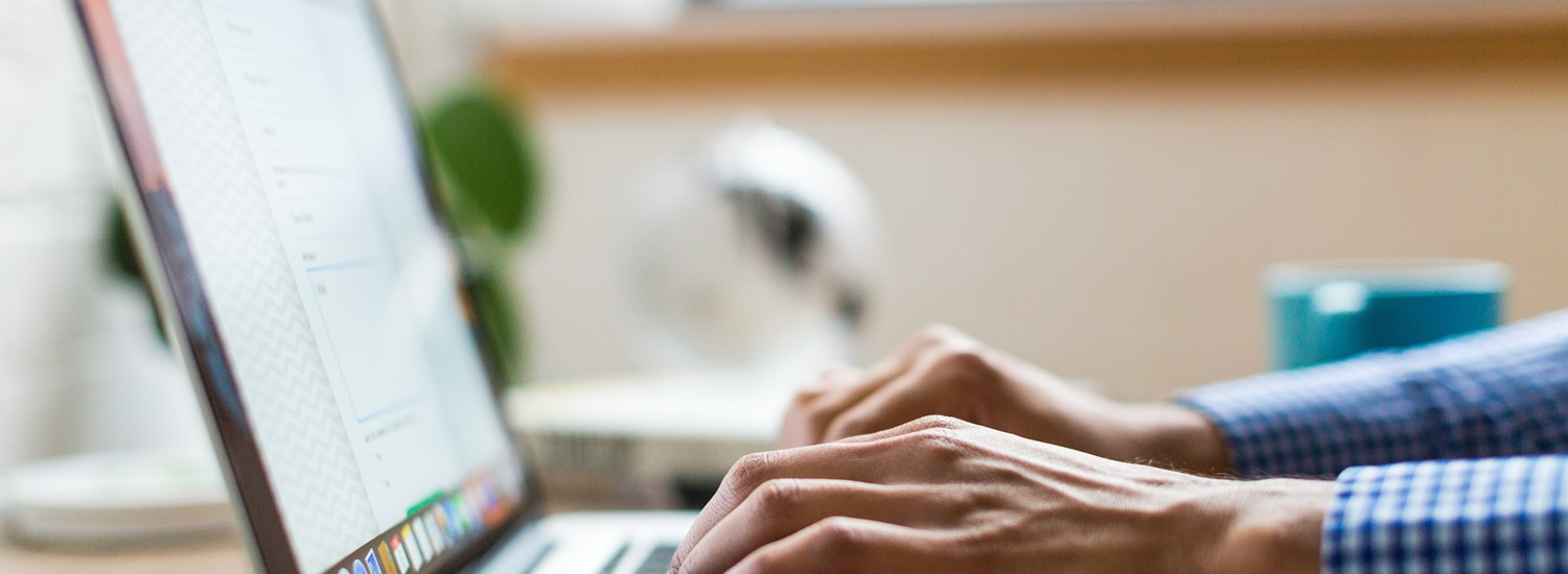 Close up of laptop with person typing 