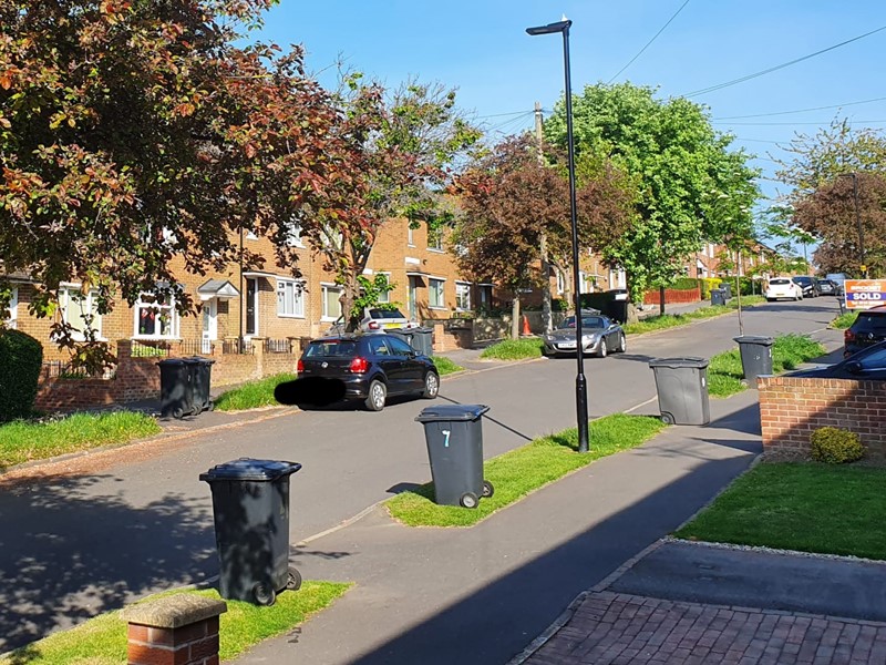 Black bins on side of road