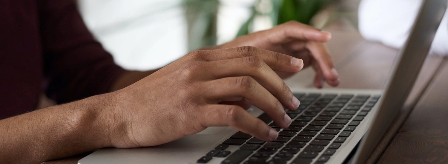 person typing on keyboard