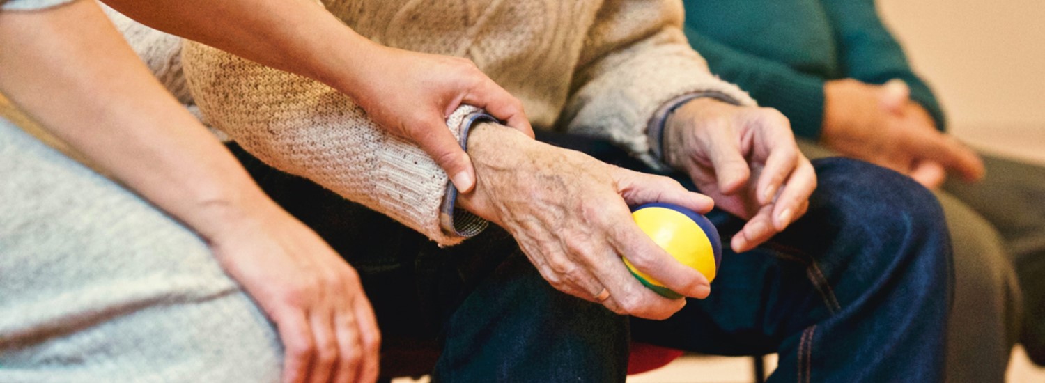 Care worker reassuring elderly man
