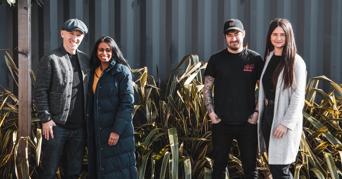 Four people stood in front of building