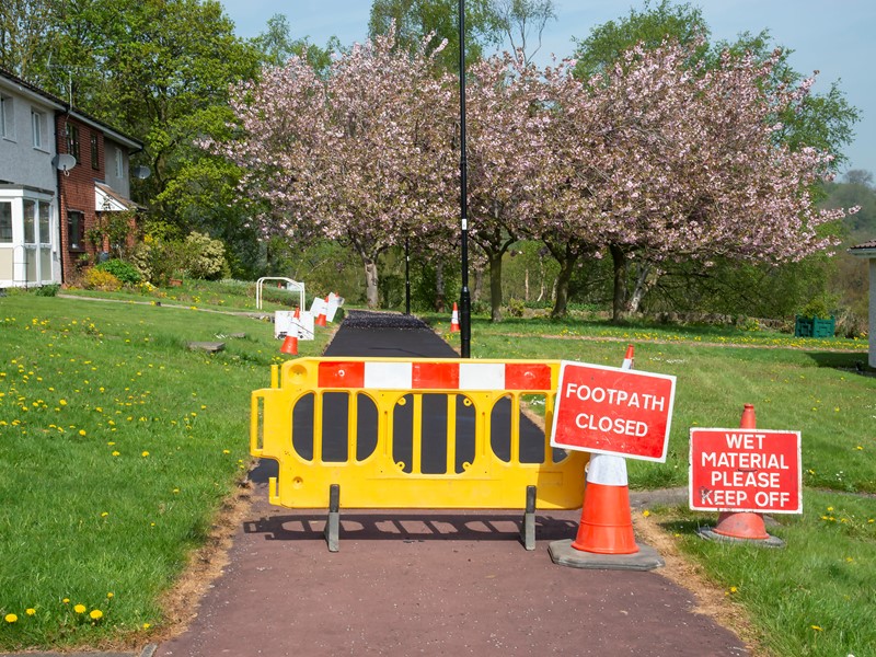 Barriers infront of resurfaced pavement