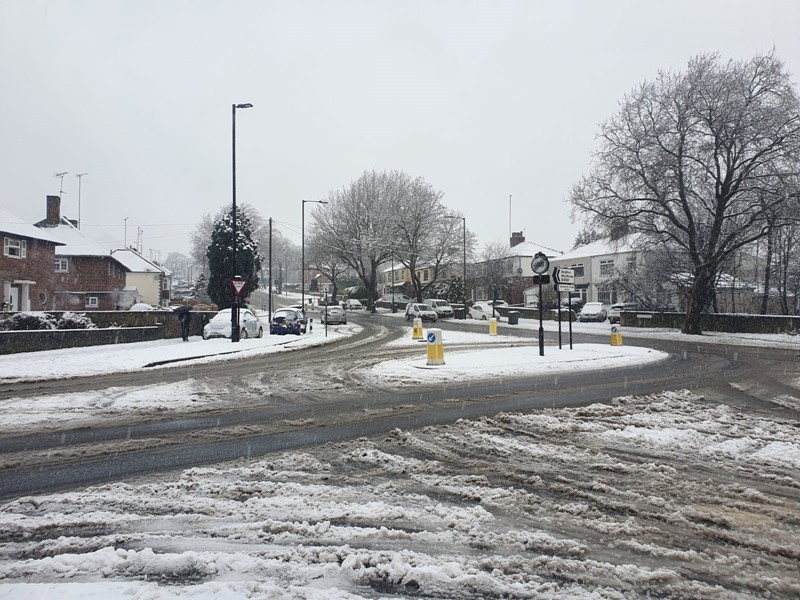 Snow on roads with trees 