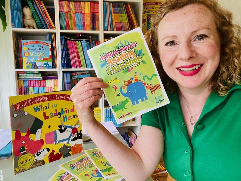 Illustrator Lydia Monks holding Sheffield Libraries Reading Challenge Flyer