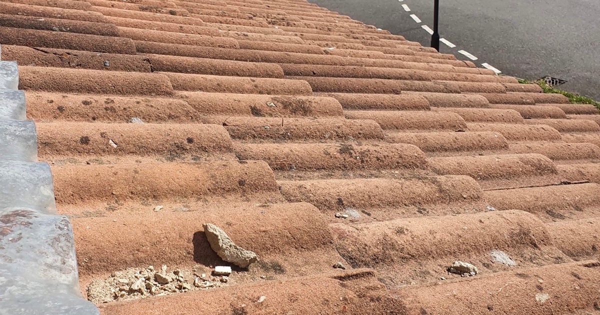 Damaged brown roof tiles