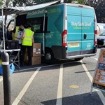 Community Covid bus parked up in car park with staff preparing it for the day ahead