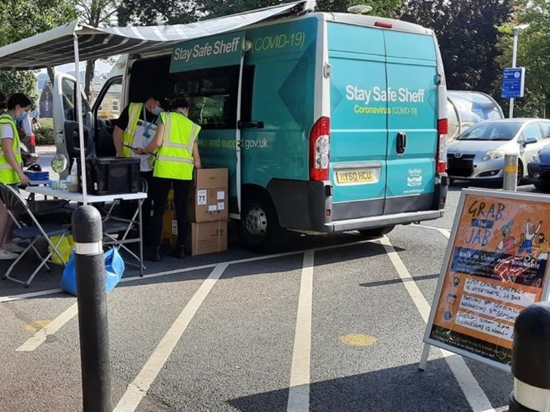 Community Covid bus parked up in car park with staff preparing it for the day ahead