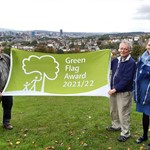 People holding green flag in Meersbrook Park