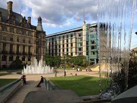 Town hall with the fountains on view, a sunny day with clouds