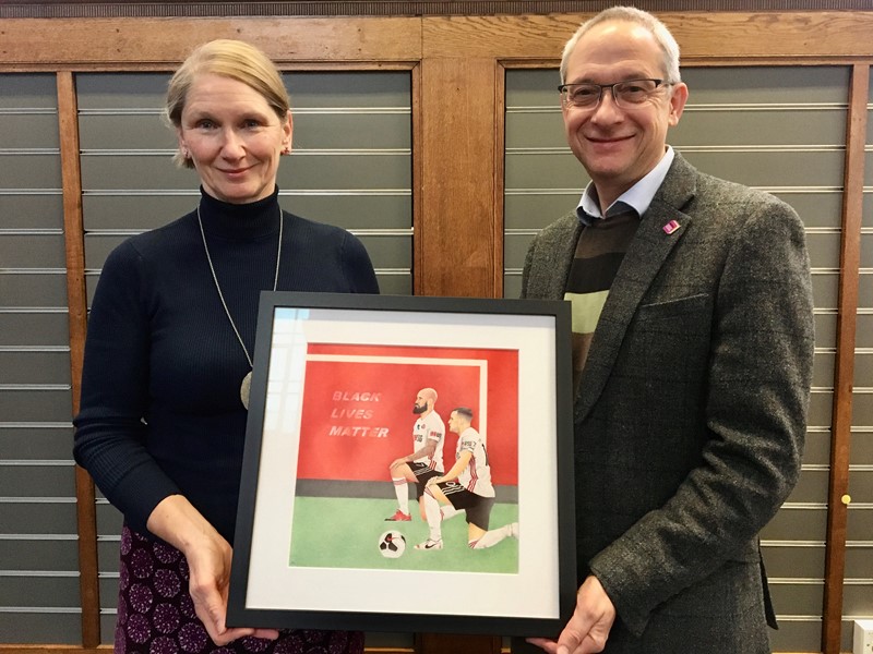 Cllr Alison Teal and Nick Partridge Director of Libraries hold Black Lives Matter framed artwork