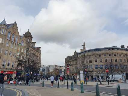 Shoppers and visitors walk through Sheffield City Centre