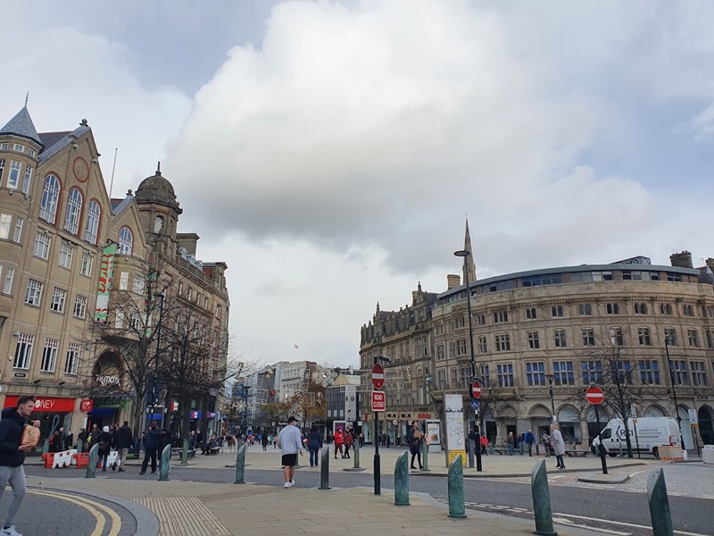 Shoppers and visitors walk through Sheffield City Centre