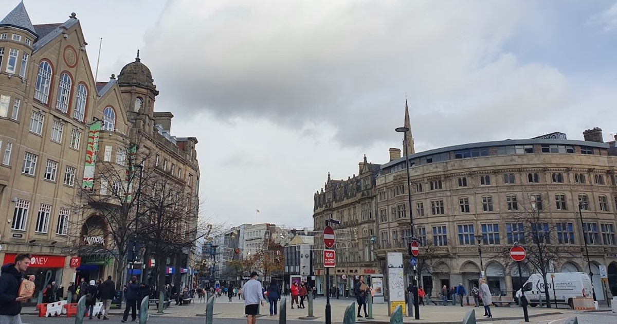 Shoppers and visitors walk through Sheffield City Centre