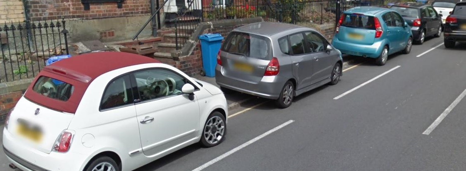 Cars parked on pavement 