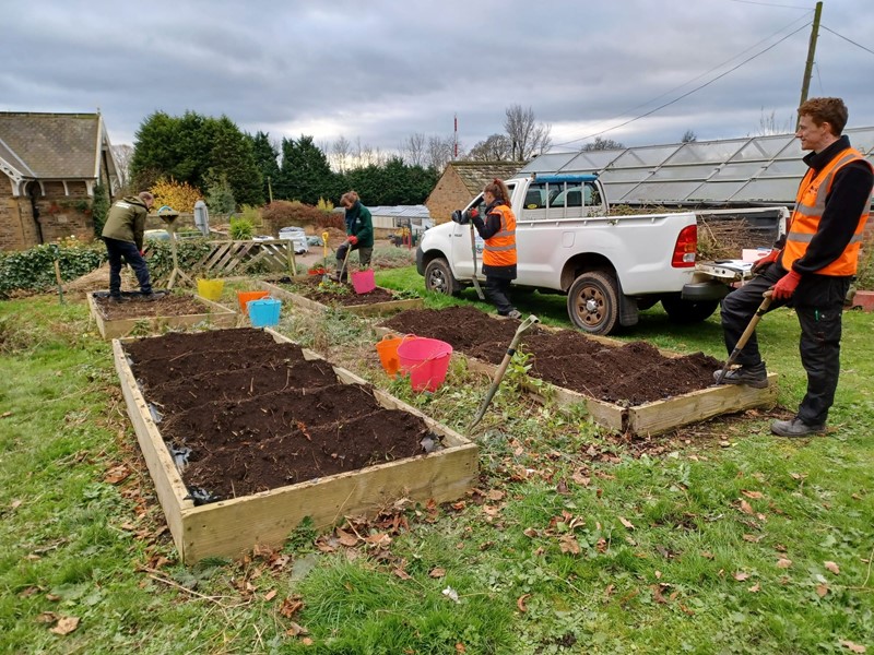 Community forestry team digging beds for trees