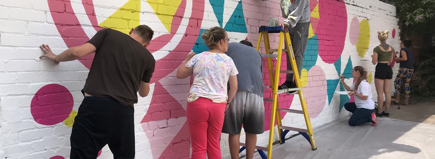 Local people paint wall mural led by 'Artworks'