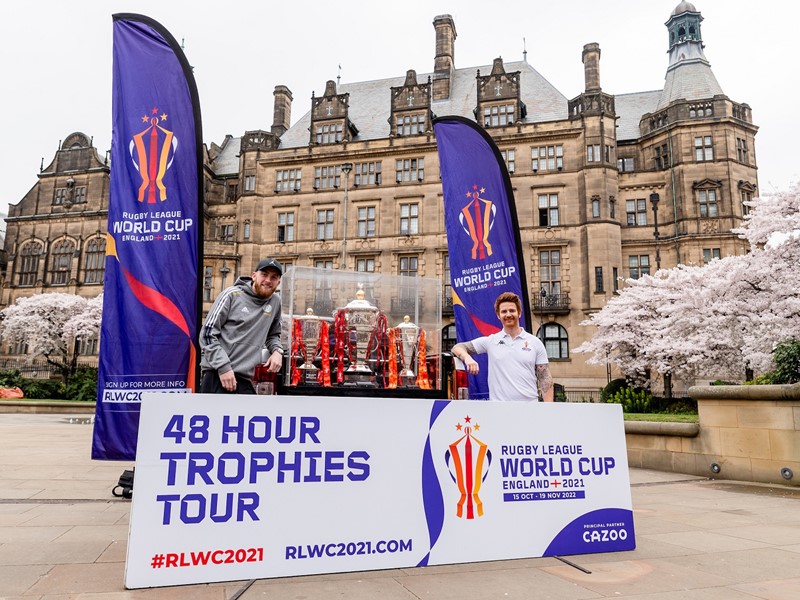 Sheffield United striker Oli McBurnie and Rugby League World Cup Ambassador James Simpson in Peace Gardens with Rugby League trophies