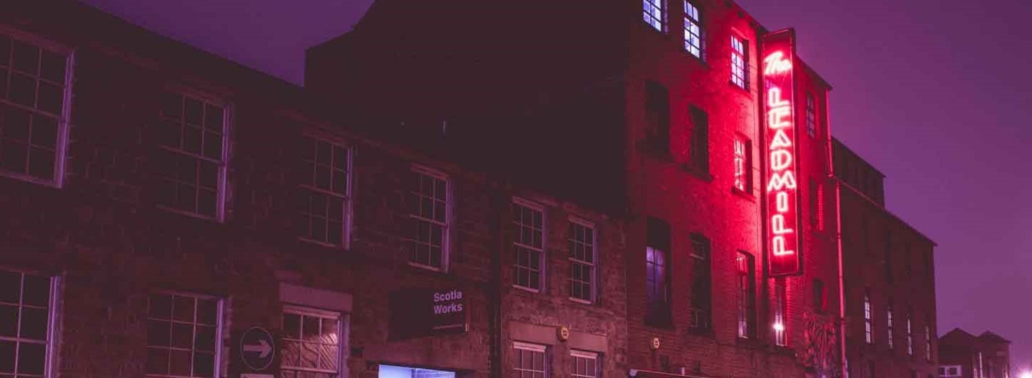 The Leadmill at night, lit up by a red neon light with the name of the venue 