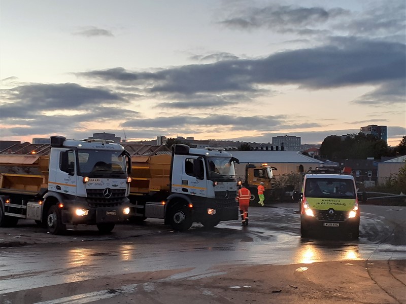 Gritting lorries parked with cloudy sky
