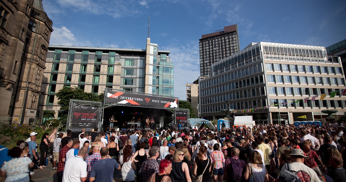 A crowd engage the entertainment at Fringe at Tramlines in the Peace Gardens