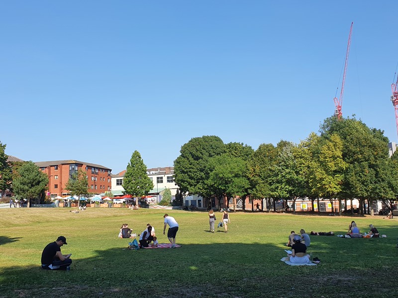 People sitting on the grass on Devonshire Green