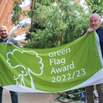 Liam Pond stands with Councillor Richard Williams, proudly holding the Green Flag award in Sheffield Winter Garden