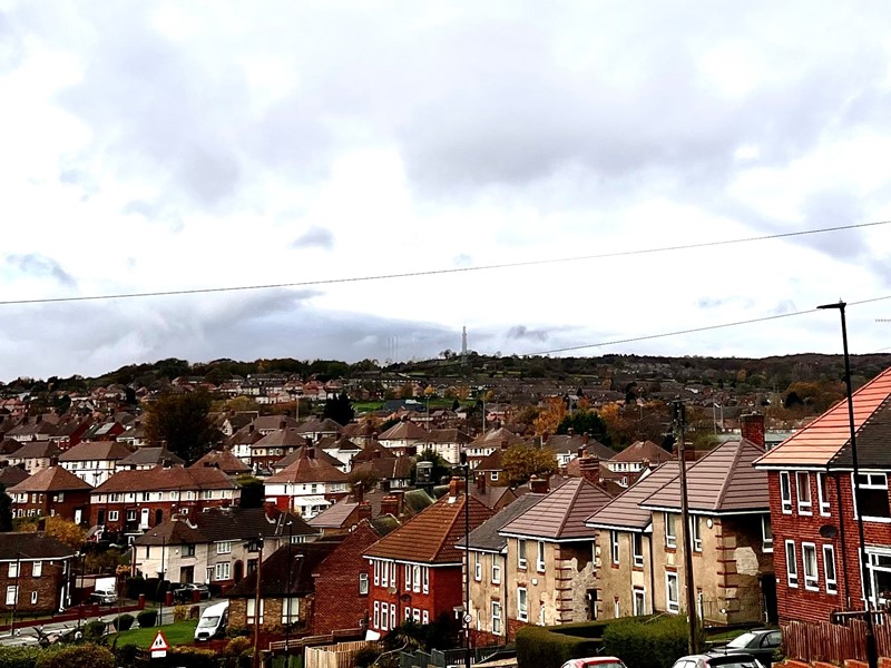 Rows of houses at Southey Green with grey sky looking over the valley
