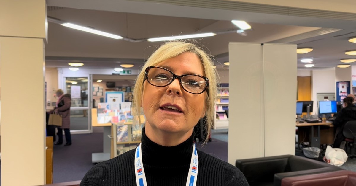 Allison Doyle standing in neighbourhood office and library 