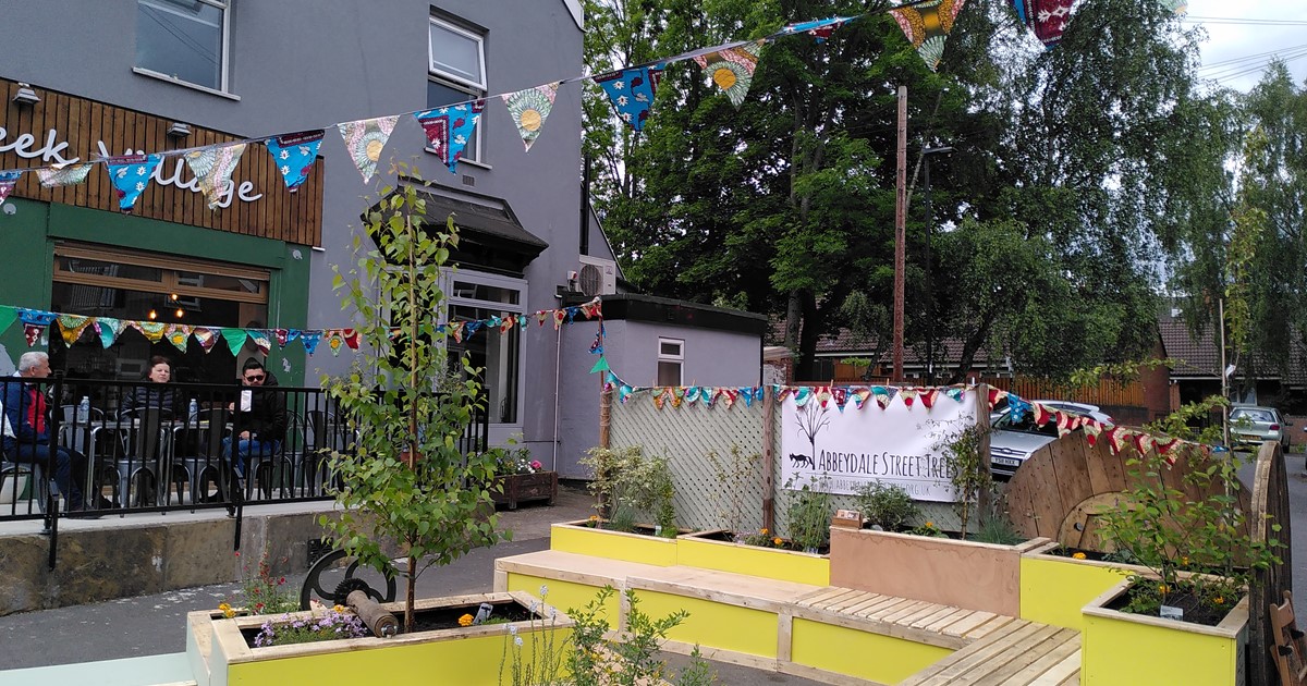 A colourful seating area with new planters and bunting