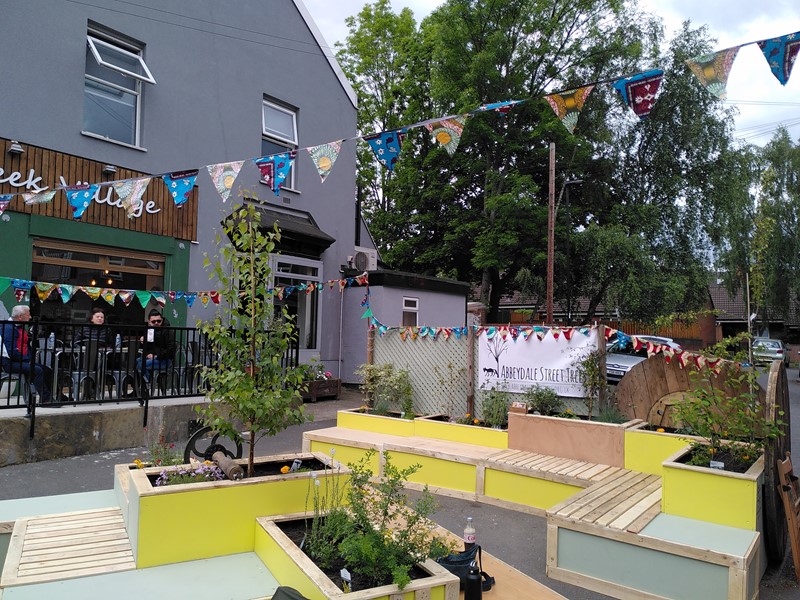 A colourful seating area with new planters and bunting