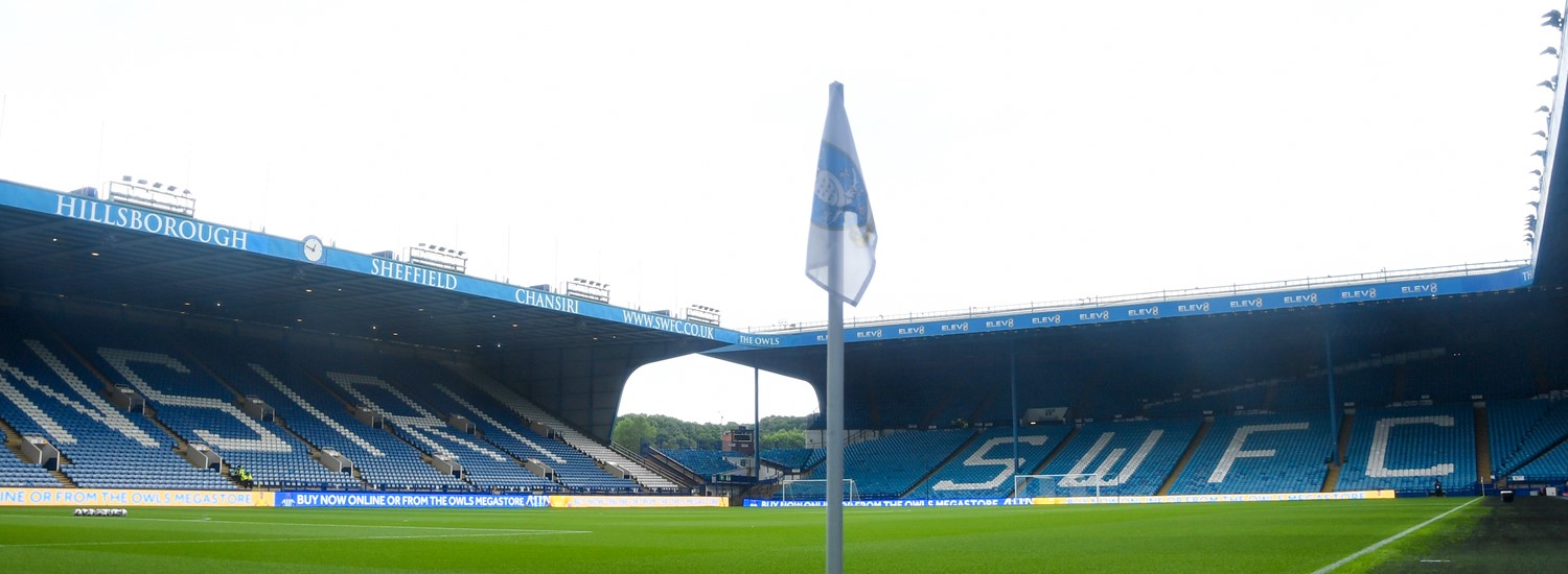 Picture of Sheffield Wednesday football pitch, at the edge, showing the corner flag and the seats in the background